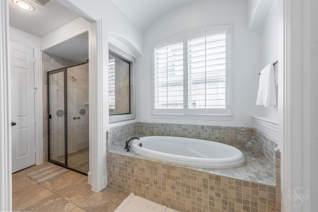 full bathroom featuring a garden tub, a stall shower, and tile patterned floors