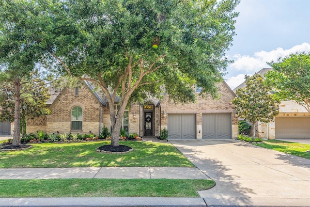 view of front of property featuring concrete driveway, a garage, brick siding, and a front lawn