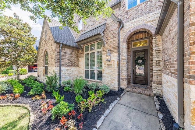 entrance to property with brick siding and stone siding