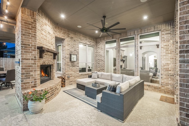 view of patio / terrace featuring a ceiling fan and an outdoor living space with a fireplace