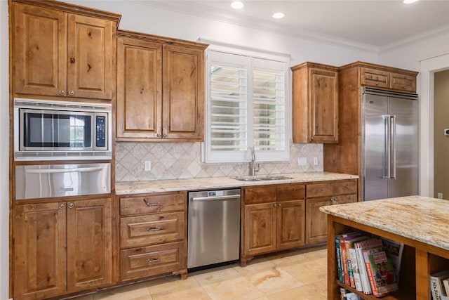 508 Golden Bear Dr, Austin, TX 78738 - kitchen with brown cabinetry, built in appliances, a sink, and a warming drawer