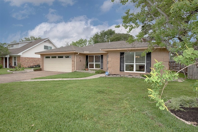 ranch-style home featuring a garage, fence, concrete driveway, a front lawn, and brick siding