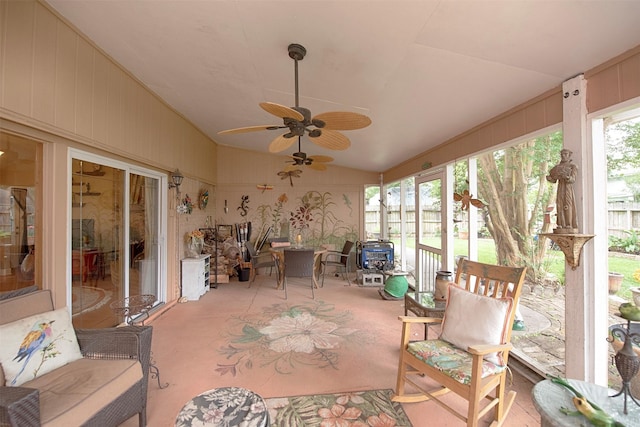 sunroom / solarium featuring lofted ceiling, carpet floors, and a ceiling fan
