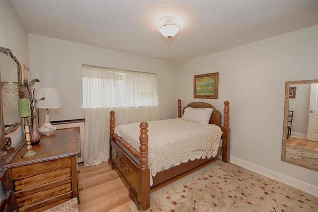 bedroom featuring baseboards and light wood-type flooring