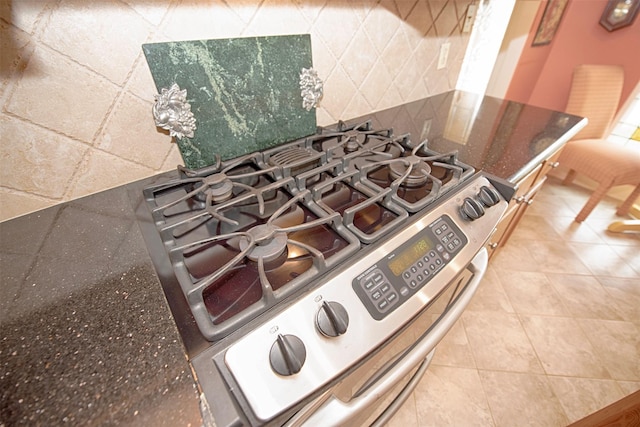room details featuring gas range and dark stone countertops