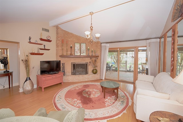 living room with lofted ceiling with beams, wood finished floors, visible vents, a chandelier, and baseboards