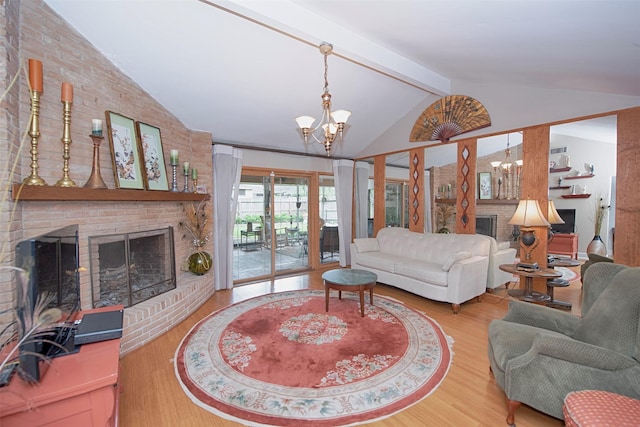 living area with a chandelier, wood finished floors, a brick fireplace, and vaulted ceiling with beams