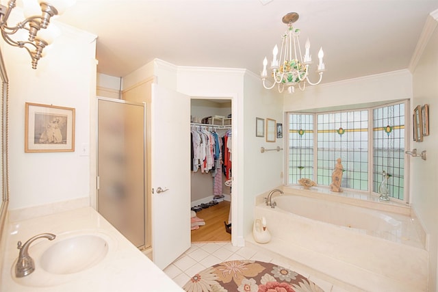 full bathroom with tile patterned floors, an inviting chandelier, a shower stall, a walk in closet, and a garden tub