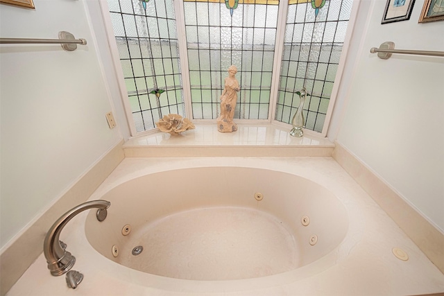 bathroom featuring a tub with jets and plenty of natural light