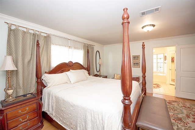 bedroom with light wood finished floors, multiple windows, visible vents, and ornamental molding
