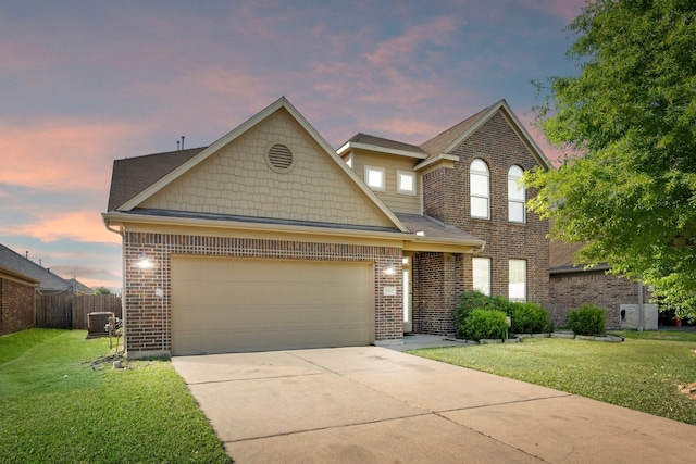 1902 Red Cedar Trl, Rosenberg, TX 77471 - traditional home with a lawn, brick siding, fence, an attached garage, and concrete driveway