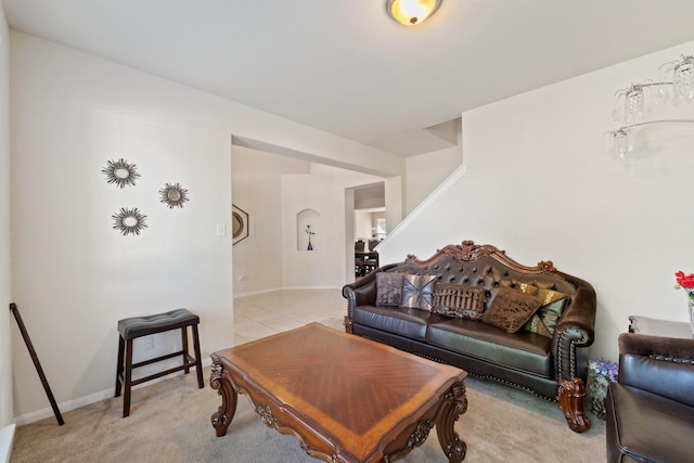 1902 Red Cedar Trl, Rosenberg, TX 77471 - living room featuring light colored carpet, stairs, and arched walkways