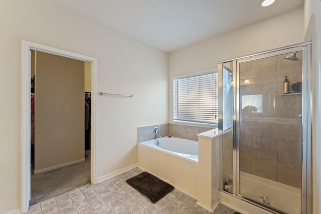 1902 Red Cedar Trl, Rosenberg, TX 77471 - full bath with a walk in closet, a garden tub, a shower stall, and baseboards