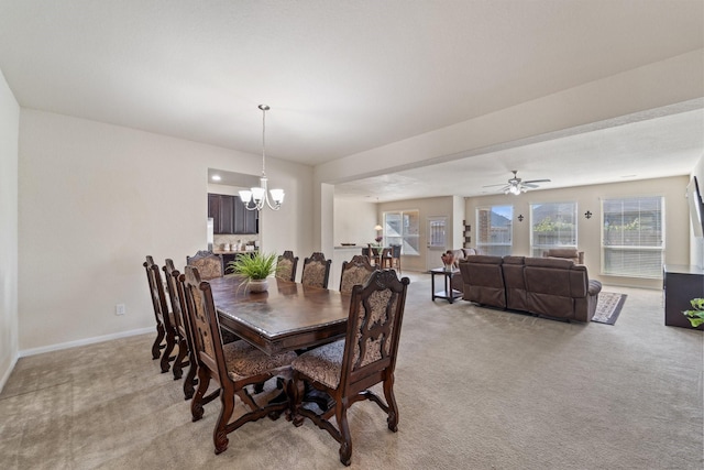 1902 Red Cedar Trl, Rosenberg, TX 77471 - dining space with baseboards, light carpet, and ceiling fan with notable chandelier