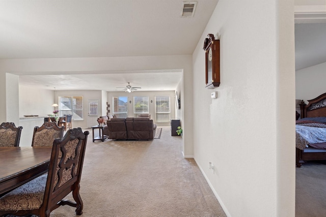 1902 Red Cedar Trl, Rosenberg, TX 77471 - dining area with light colored carpet, visible vents, baseboards, and ceiling fan