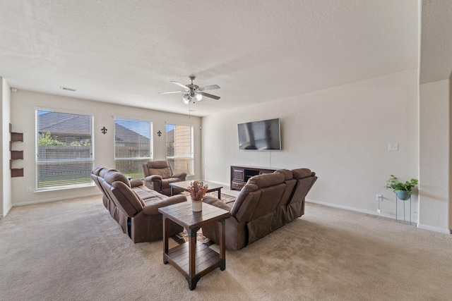 1902 Red Cedar Trl, Rosenberg, TX 77471 - living area featuring light carpet, baseboards, and a ceiling fan