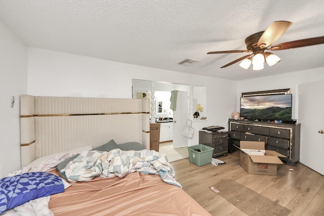 6230 Grandvale Dr, Houston, TX 77072 - bedroom featuring a textured ceiling, visible vents, wood finished floors, and ceiling fan