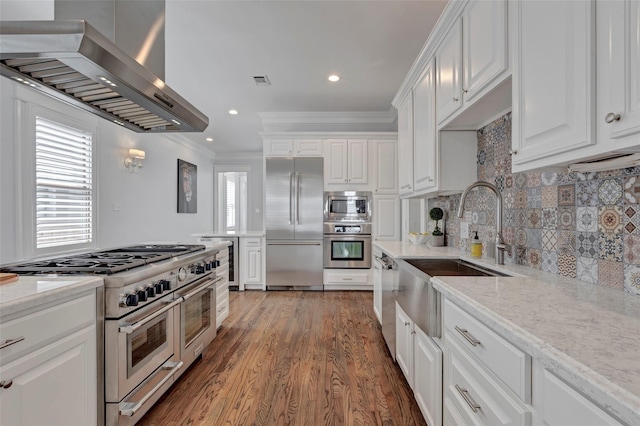 1905 W 14th St Unit B, Houston, TX 77008 - kitchen with a sink, wall chimney range hood, premium appliances, crown molding, and white cabinets