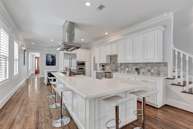 1905 W 14th St Unit B, Houston, TX 77008 - kitchen featuring a sink, built in appliances, visible vents, island range hood, and white cabinetry