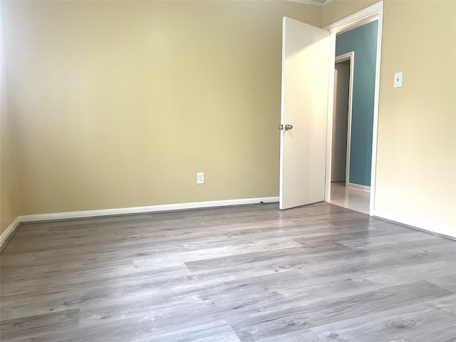 empty room featuring baseboards and wood finished floors