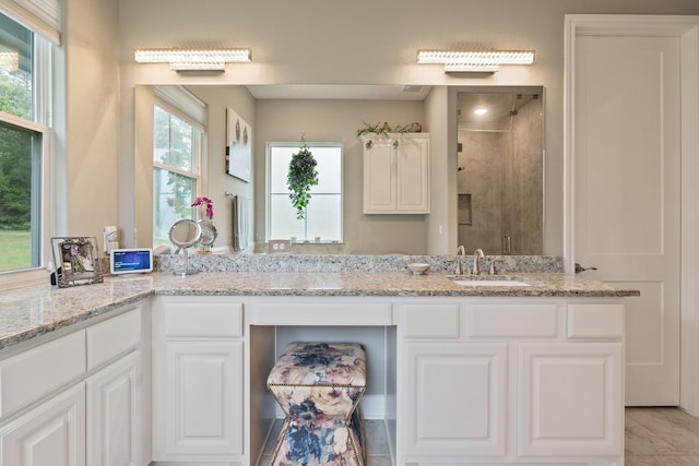 bathroom featuring vanity and a shower stall