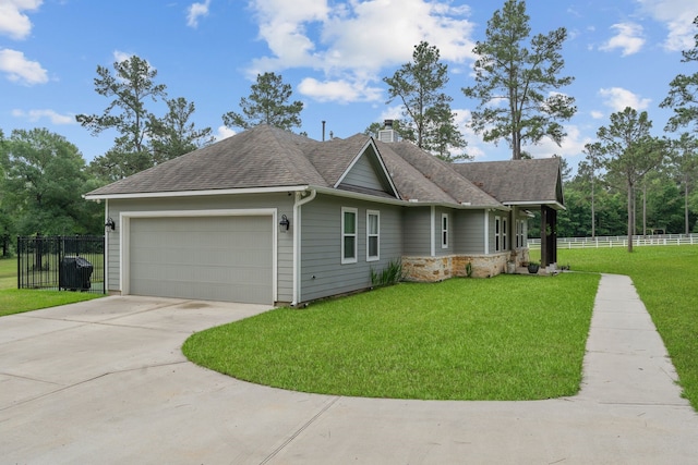 view of front of house featuring fence, driveway, a garage, a front lawn, and a chimney
