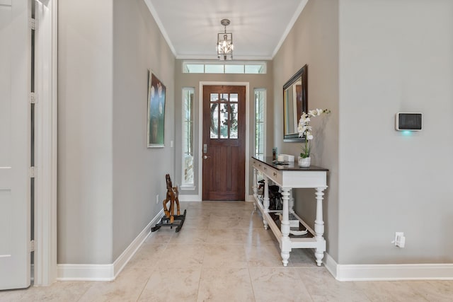 entryway with baseboards, ornamental molding, light tile patterned floors, and a chandelier