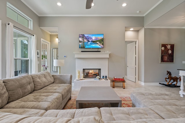 living area featuring a fireplace, ornamental molding, baseboards, and recessed lighting
