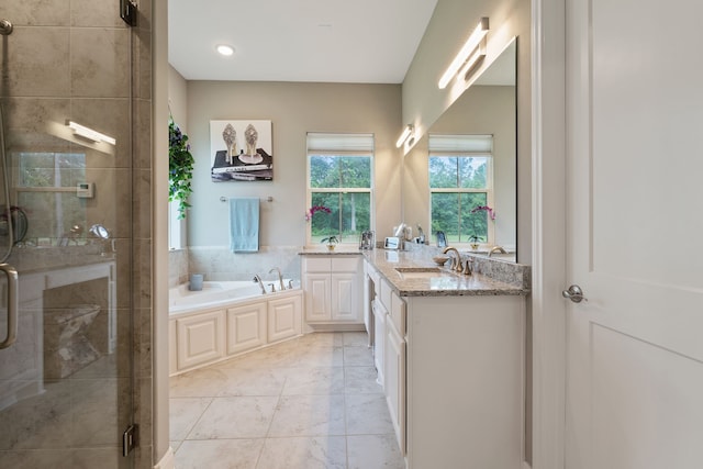 full bathroom featuring a shower stall, marble finish floor, a garden tub, and vanity