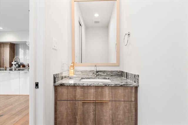 5203 Texas St, Houston, TX 77011 - bathroom featuring vanity, wood finished floors, visible vents, and recessed lighting