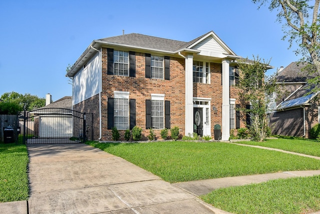 210 Needleleaf Ln, Sugar Land, TX 77479 - view of front of house with a gate, a front lawn, brick siding, and concrete driveway