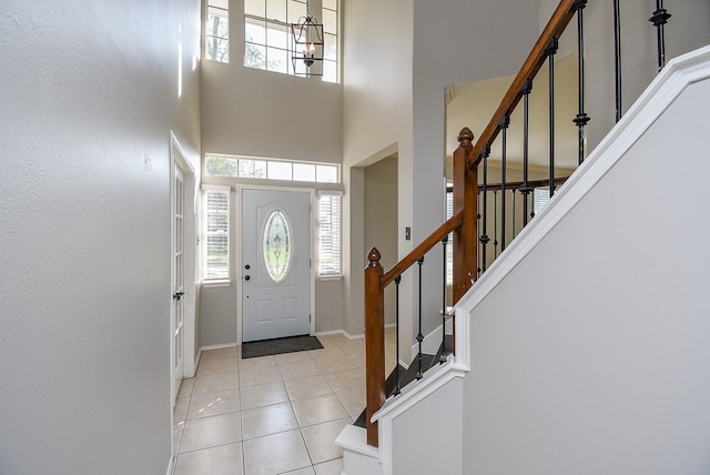210 Needleleaf Ln, Sugar Land, TX 77479 - entryway featuring light tile patterned floors, stairs, a towering ceiling, and baseboards