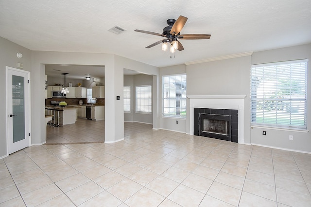 210 Needleleaf Ln, Sugar Land, TX 77479 - unfurnished living room featuring a ceiling fan, baseboards, light tile patterned flooring, and a fireplace
