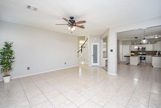 210 Needleleaf Ln, Sugar Land, TX 77479 - unfurnished living room featuring ceiling fan, light tile patterned floors, stairway, and baseboards