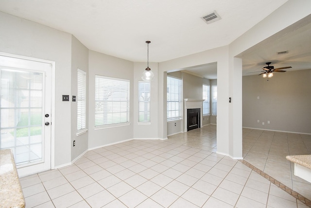 210 Needleleaf Ln, Sugar Land, TX 77479 - unfurnished dining area with light tile patterned floors, baseboards, ceiling fan, and a fireplace