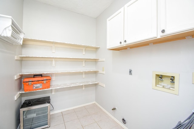 210 Needleleaf Ln, Sugar Land, TX 77479 - laundry room featuring washer hookup, hookup for an electric dryer, cabinet space, light tile patterned floors, and baseboards