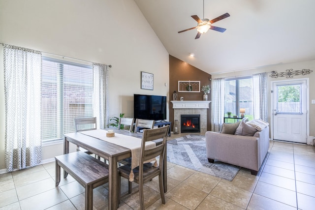 246 Bayside Crossing Dr, La Porte, TX 77571 - dining area featuring high vaulted ceiling, a tiled fireplace, baseboards, ceiling fan, and light tile patterned flooring