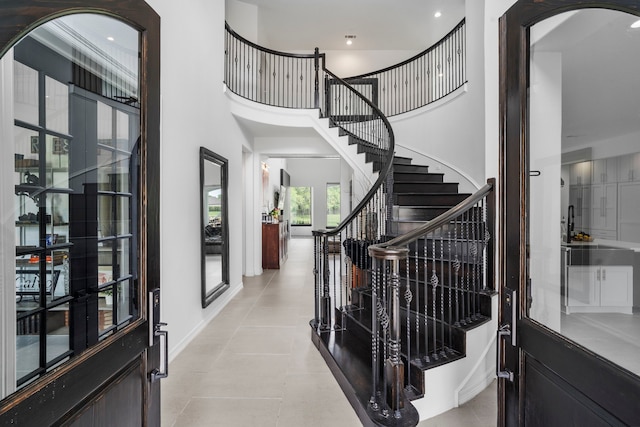 8603 Royal Retreat, Richmond, TX 77469 - foyer entrance featuring a towering ceiling, french doors, light tile patterned flooring, and stairs