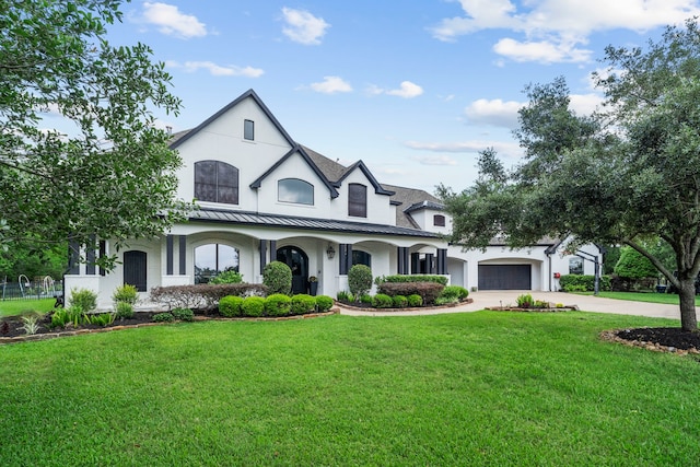 8603 Royal Retreat, Richmond, TX 77469 - view of front of home with a front lawn, stucco siding, driveway, and a standing seam roof