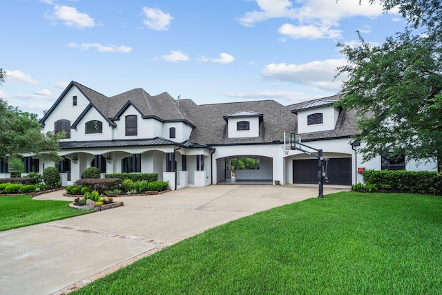 8603 Royal Retreat, Richmond, TX 77469 - french country style house with concrete driveway, a garage, stucco siding, a front yard, and a standing seam roof
