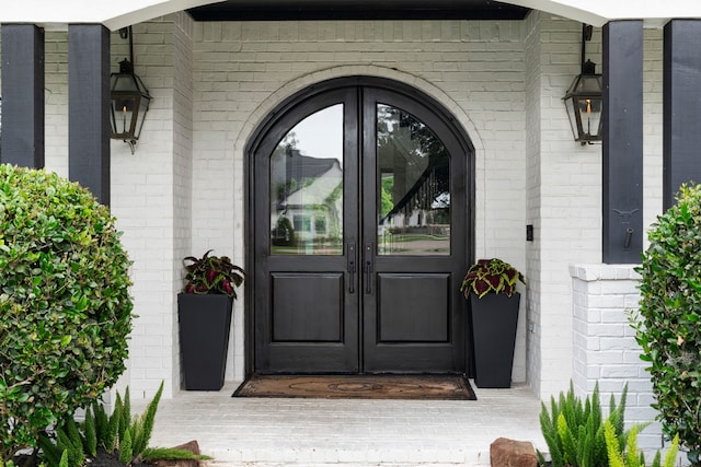 8603 Royal Retreat, Richmond, TX 77469 - doorway to property with brick siding and french doors