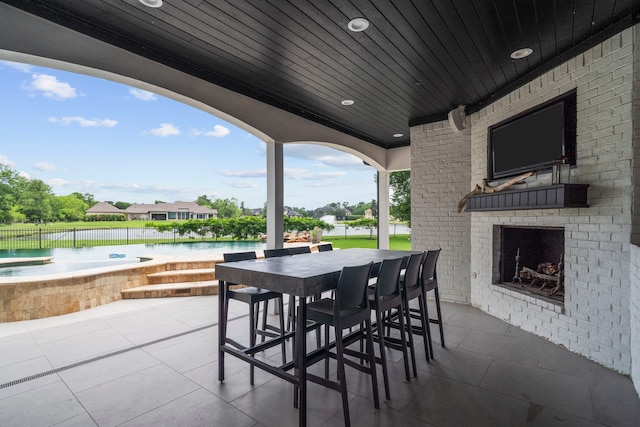 8603 Royal Retreat, Richmond, TX 77469 - view of patio / terrace with a jacuzzi, a bar, an outdoor brick fireplace, and fence