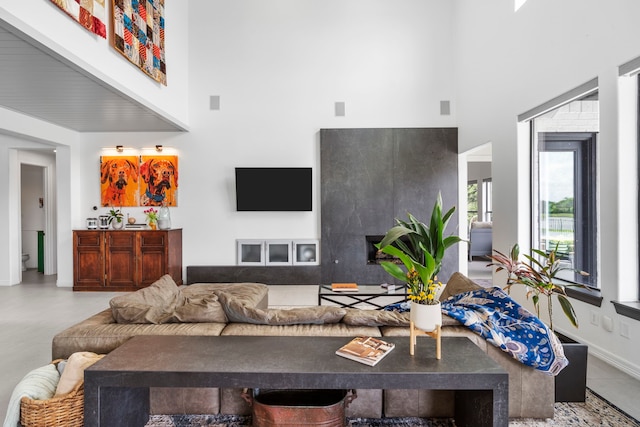8603 Royal Retreat, Richmond, TX 77469 - living room featuring baseboards, a fireplace, and a towering ceiling