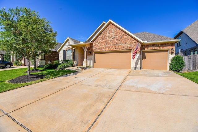 18273 Evanhale Bend Dr, Cypress, TX 77429 - view of front of home featuring brick siding, an attached garage, driveway, a shingled roof, and fence
