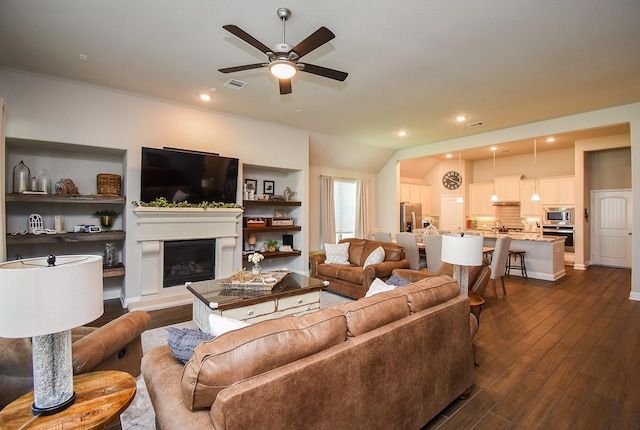 18273 Evanhale Bend Dr, Cypress, TX 77429 - living area featuring ceiling fan, dark wood finished floors, a glass covered fireplace, and recessed lighting