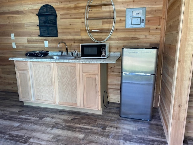 415 5th St, San Leon, TX 77539 - bar with freestanding refrigerator, wooden walls, a sink, and dark wood-type flooring