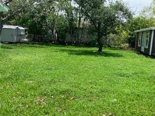 415 5th St, San Leon, TX 77539 - view of yard featuring an outbuilding and a storage shed