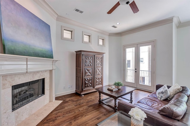 living room with french doors, wood finished floors, visible vents, crown molding, and a ceiling fan