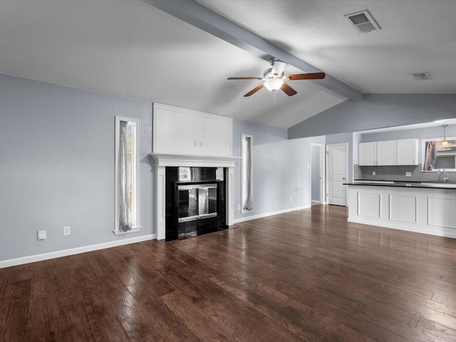 1922 Tracy Lynn Ln, Alvin, TX 77511 - unfurnished living room featuring a sink, a ceiling fan, a fireplace with flush hearth, dark wood-style floors, and baseboards
