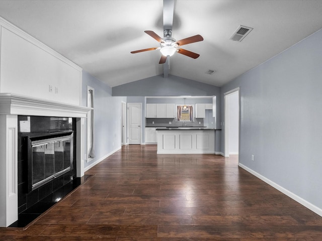 1922 Tracy Lynn Ln, Alvin, TX 77511 - unfurnished living room with a ceiling fan, baseboards, a fireplace, dark wood-style flooring, and a sink